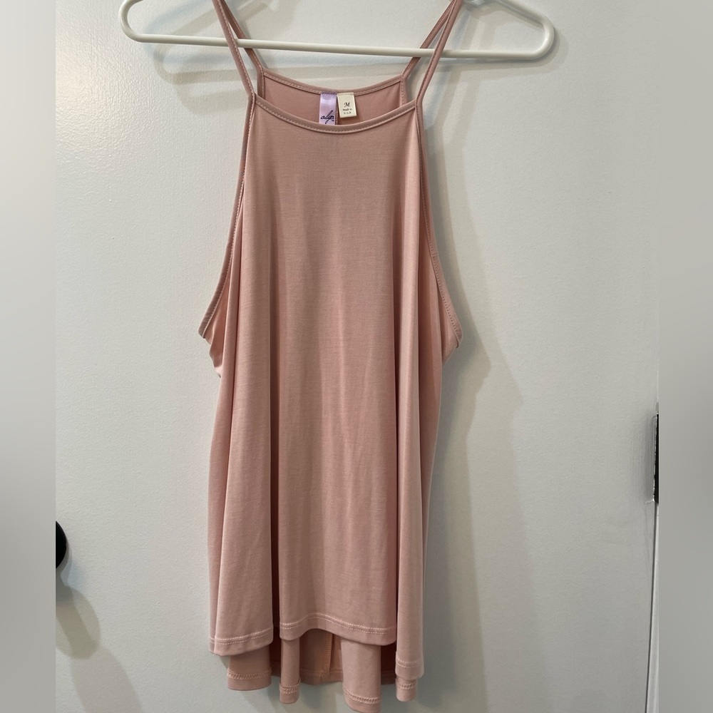 Francesca’s light pink tank top.